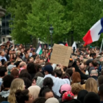 Protesters holding signs at an anti-Islamophobia demonstration in Paris after the fatal mosque attack in La Grand Combe.
