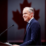 Mark Carney at a podium addressing supporters with a Canadian flag behind him at the Liberal Party election event