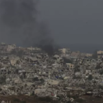 Smoke rising above buildings in Gaza as seen from a distance in southern Israel.