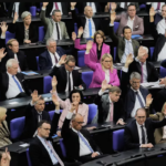 Parliament members raise hands in a vote at the Bundestag for Friedrich Merz’s election as German chancellor.