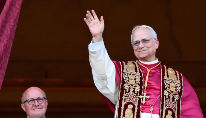 Newly elected Pope Leo XIV, Cardinal Robert Francis Prevost, waves to the crowd from the central loggia of St. Peter's Basilica in Vatican City, after his election as the new pope.