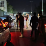 Pakistani police officers clearing the entrance of Nur Khan airbase after reported Indian missile strike.