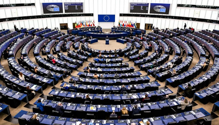 Strasbourg European Parliament building with lawmakers gathered for a session on Huawei bribery allegations and immunity revocation.