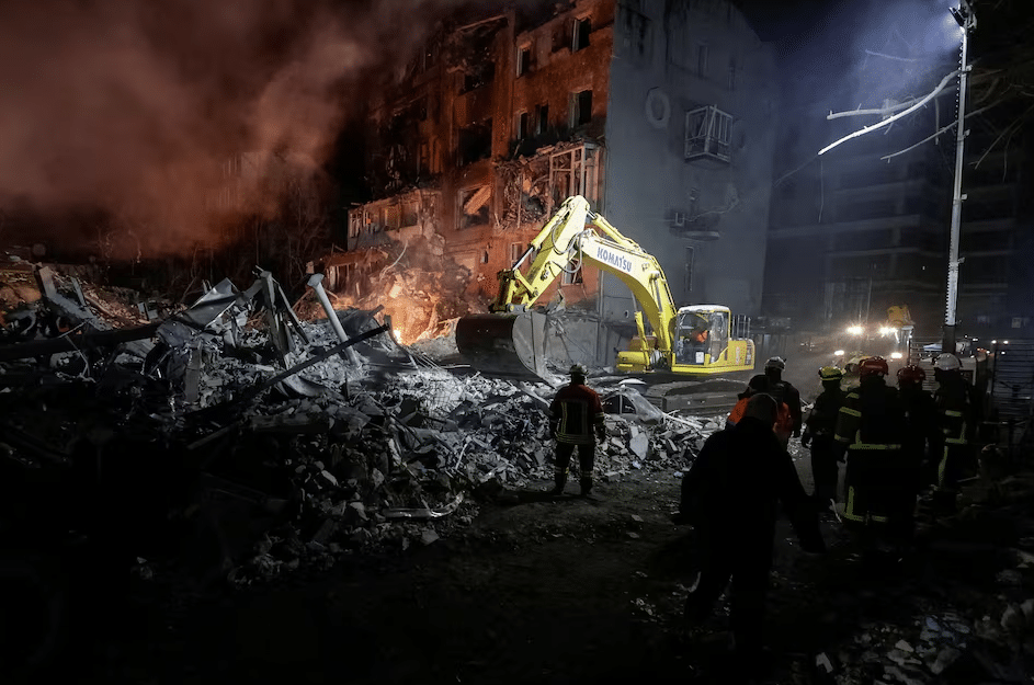 Dark street in Dnipropetrovsk with cars navigating through a blackout caused by damage to power infrastructure from Russian drone attacks.