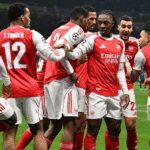 Arsenal players celebrate after scoring against Inter Milan, marking their seventh consecutive Champions League victory.