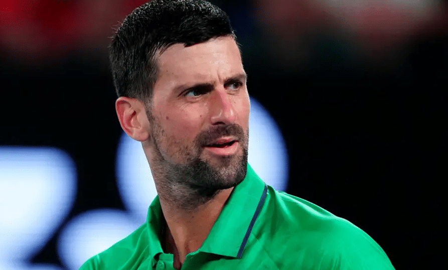 Novak Djokovic celebrates on court after winning his 100th career match at the Australian Open in Melbourne.
